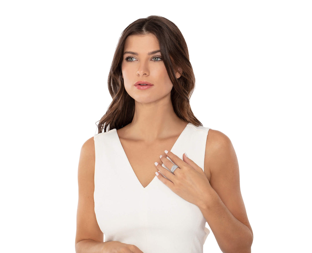 Woman wearing a white sleeveless top wearing diamond ring on a white background