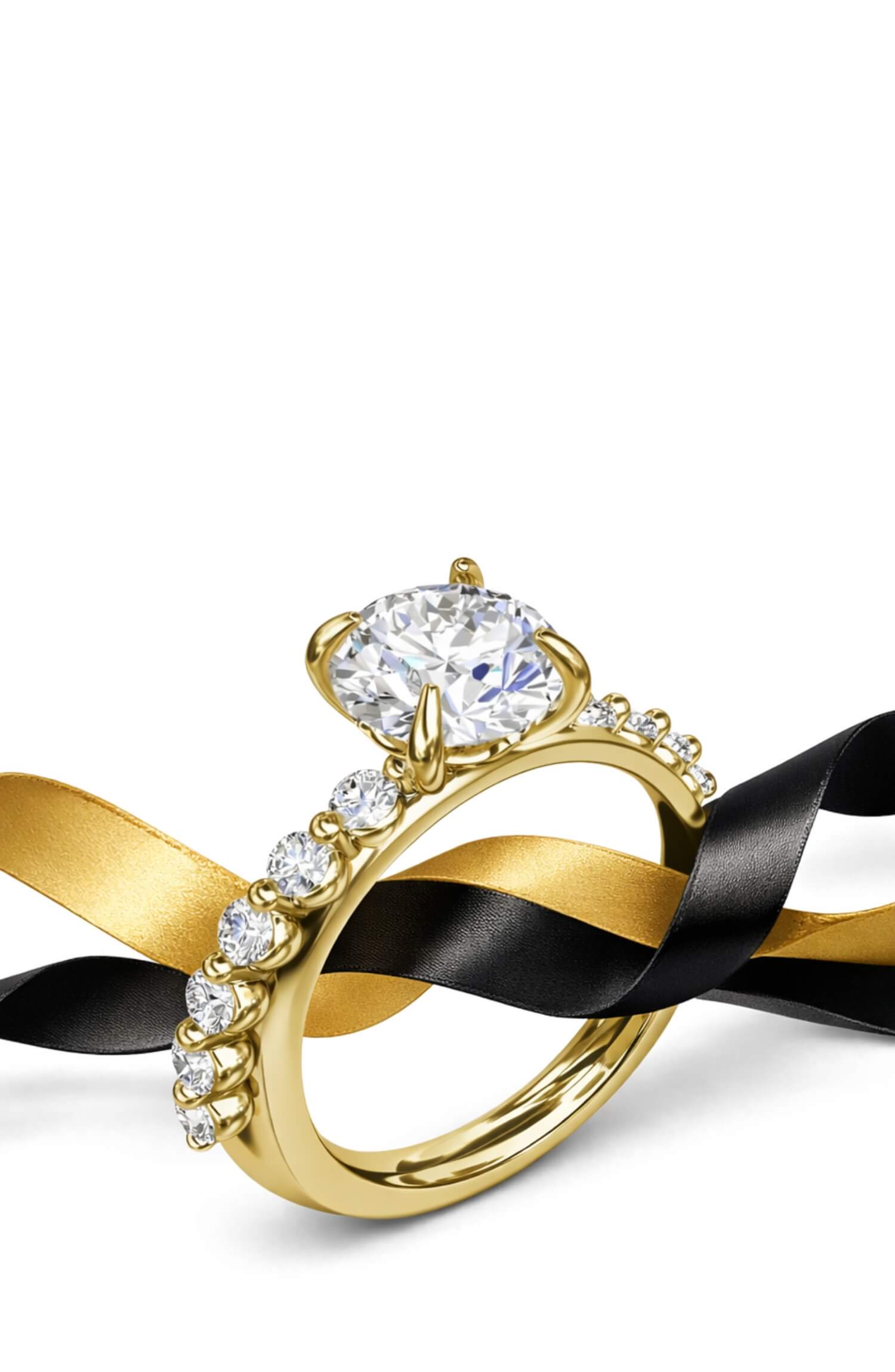 Gold ring with a large diamond and black ribbon on a white background