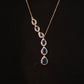 Pear-Shaped Blue Topaz Halo Drop Necklace in Yellow Gold