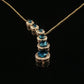 Pear-Shaped Blue Topaz Halo Drop Necklace in Yellow Gold