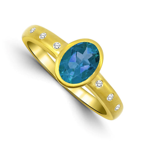 Bezel Set Oval Blue Topaz and Diamond Ring in Yellow Gold
