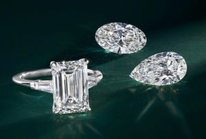 Diamond ring and two diamonds on a dark green background