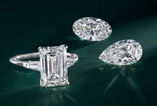 Diamond ring and two diamonds on a dark green background