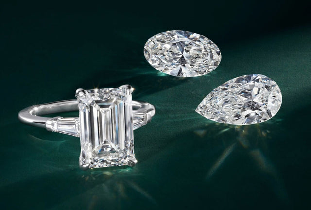 Diamond ring and earrings on a dark green background