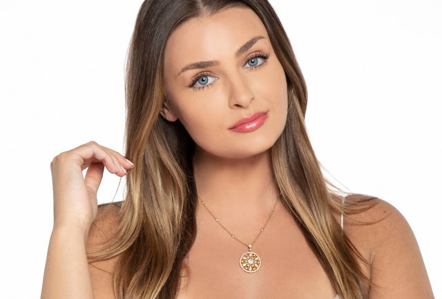 Woman wearing a gold necklace on a white background